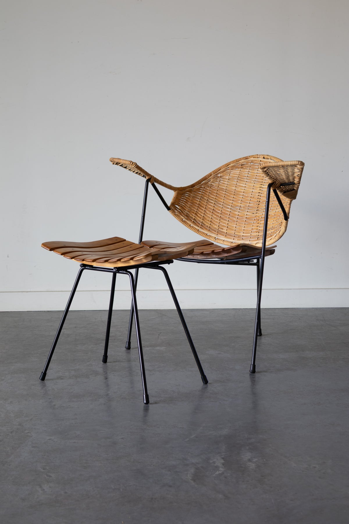 Cane and steel armchair and ottoman by Arthur Umanoff, 1955