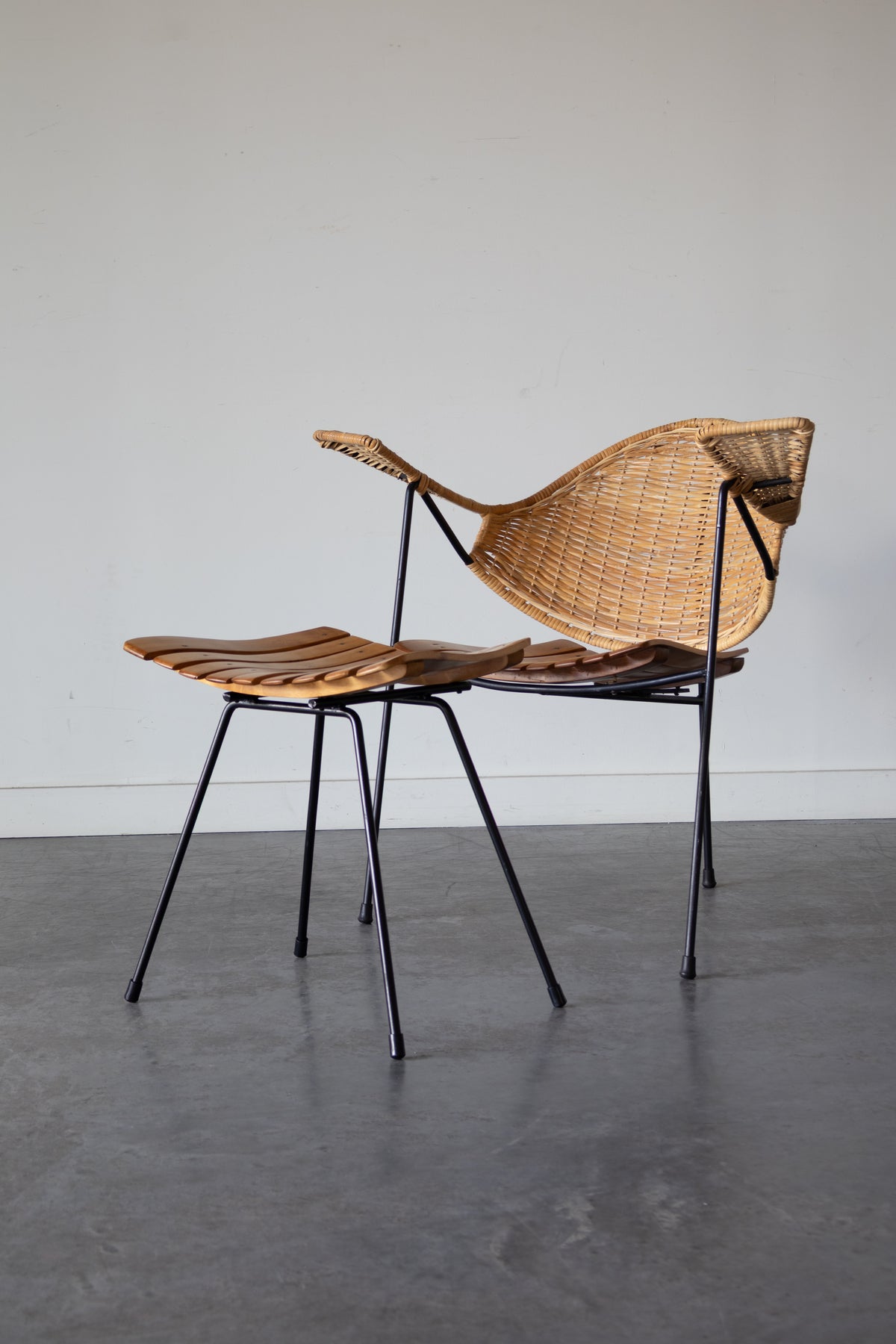 Cane and steel armchair and ottoman by Arthur Umanoff, 1955