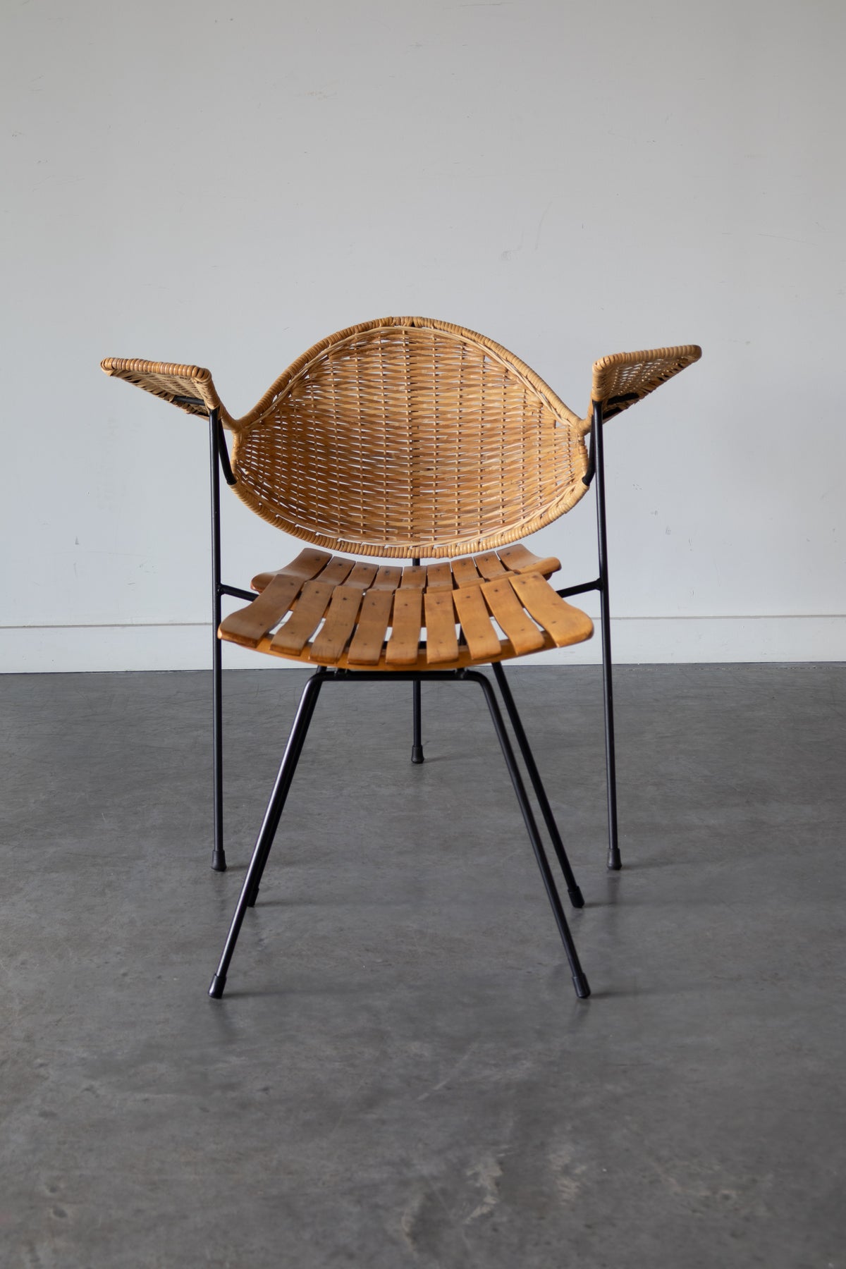 Cane and steel armchair and ottoman by Arthur Umanoff, 1955